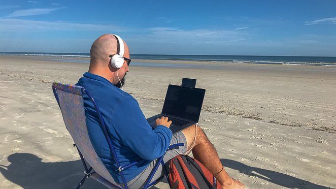 Make Money While Traveling - Digital Nomad on the beach